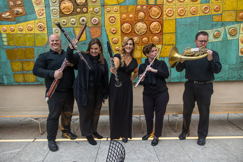 Wind quintet posing before a wedding ceremony at the Mingei Museum