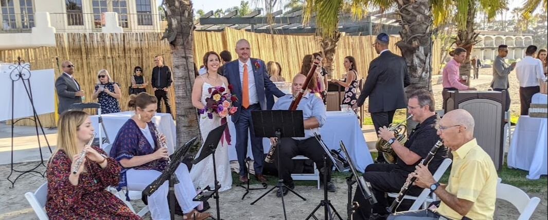 Bride and Groom with the musicians at a wedding at the Bahia in Mission Bay