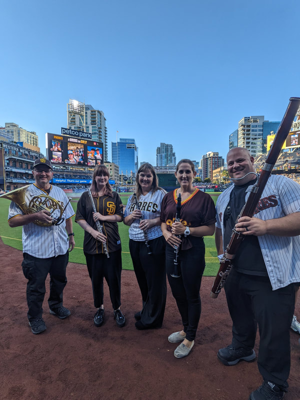 Wind quintet stands on the field at Petco Park in San Diego before performing National Anthem